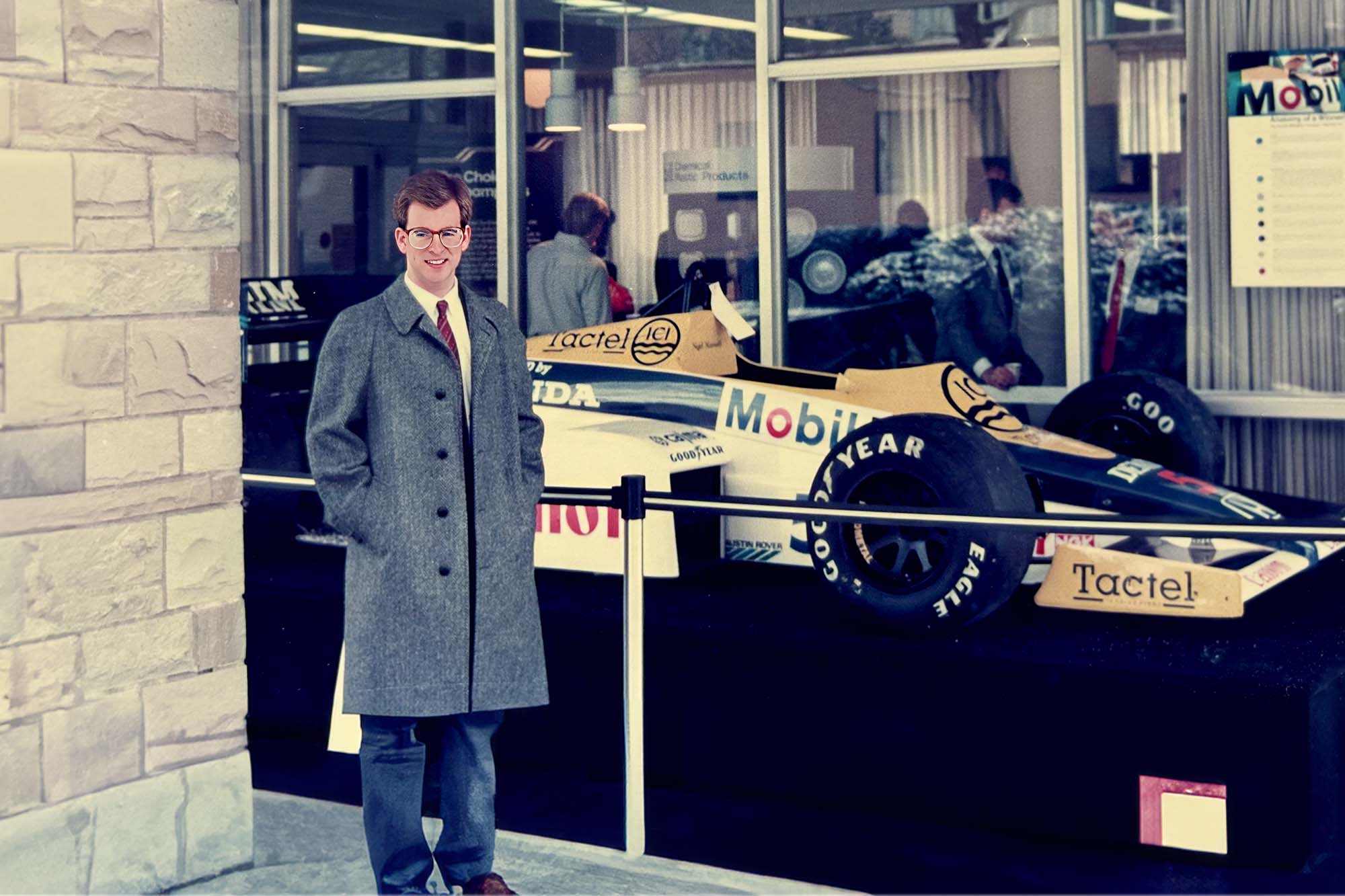 M.Eng. Alum Henio Arcangeli stands beside Mobil race car.