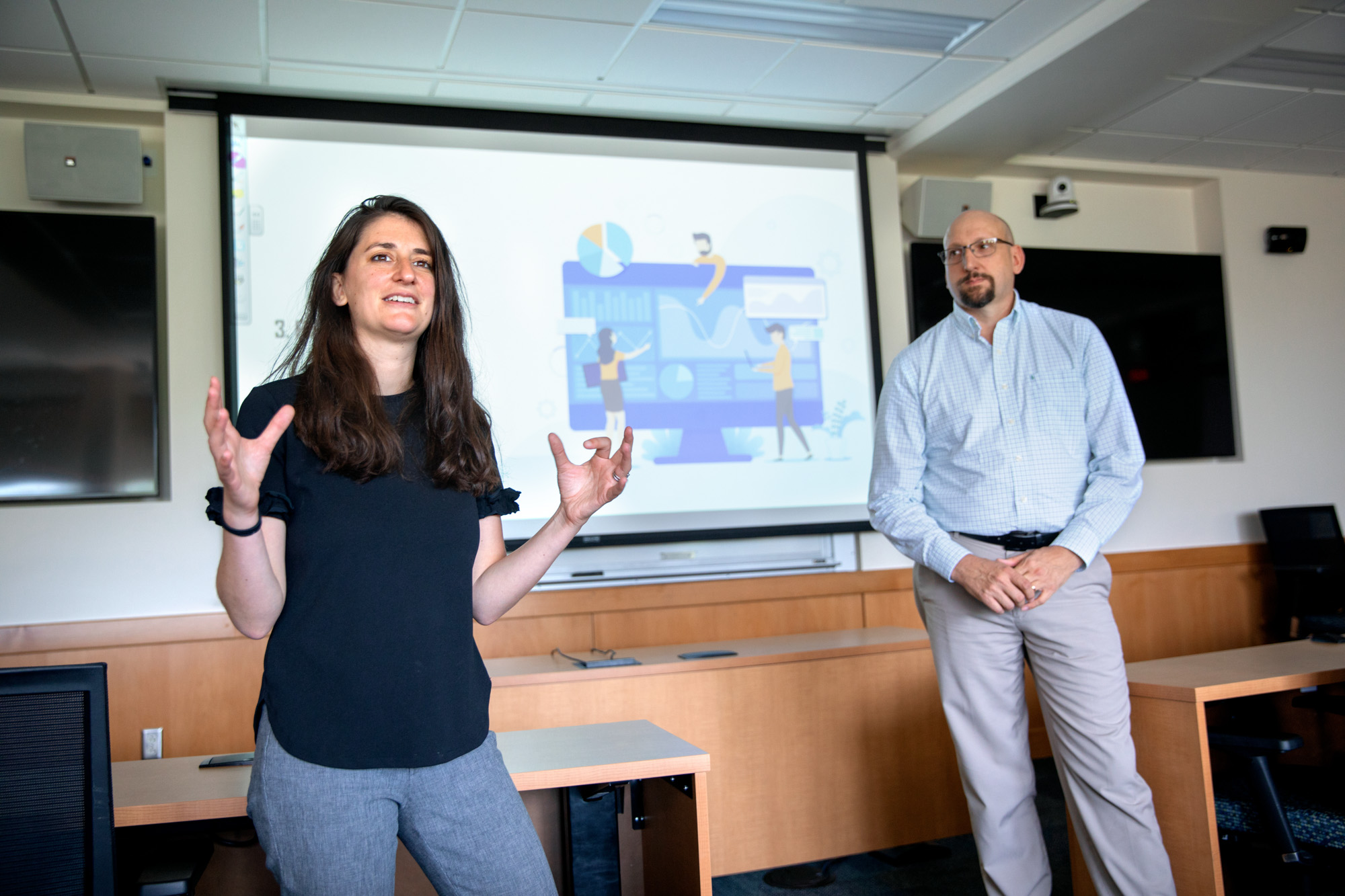 Engineering management executive director Andrea Ippolito and senior lecturer Robert Newman speaking in front of a classroom