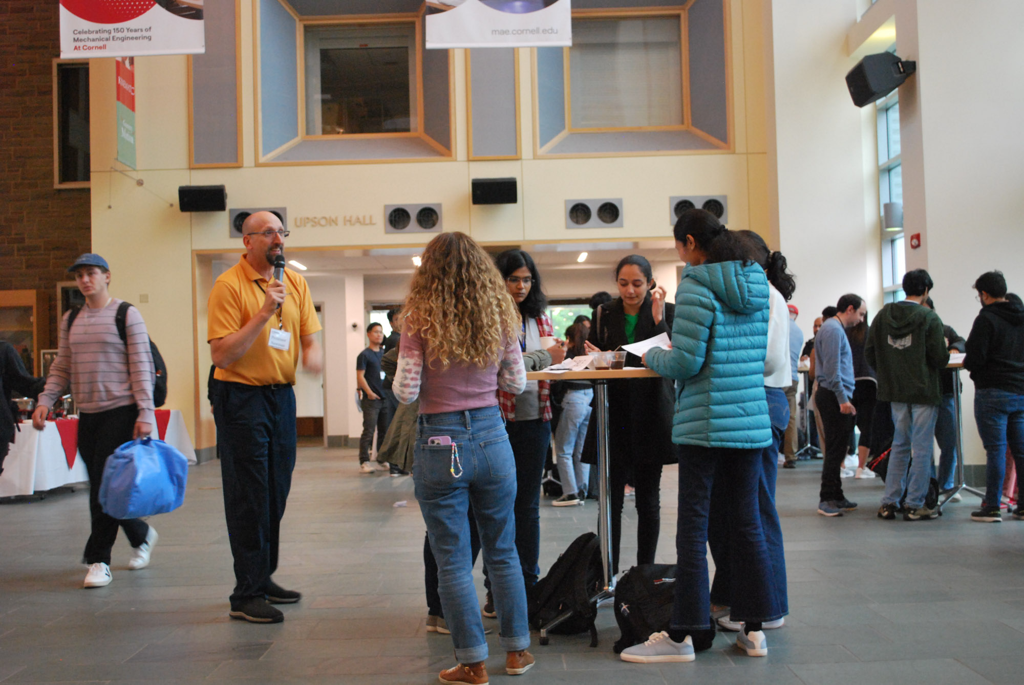 Students working on an ice breaker at tables during the engineering management networking reception in Duffield Hall