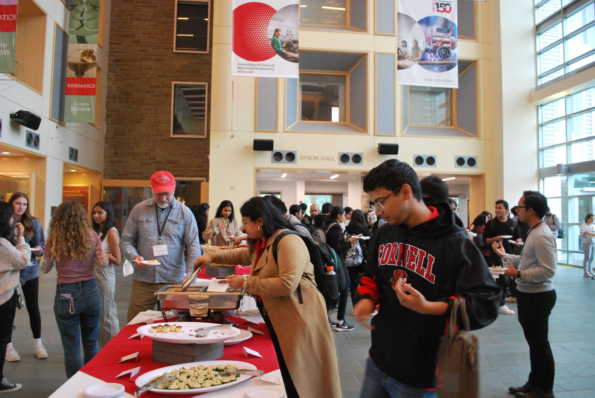 Students in the buffet line for the engineering management networking reception in Duffield Hall