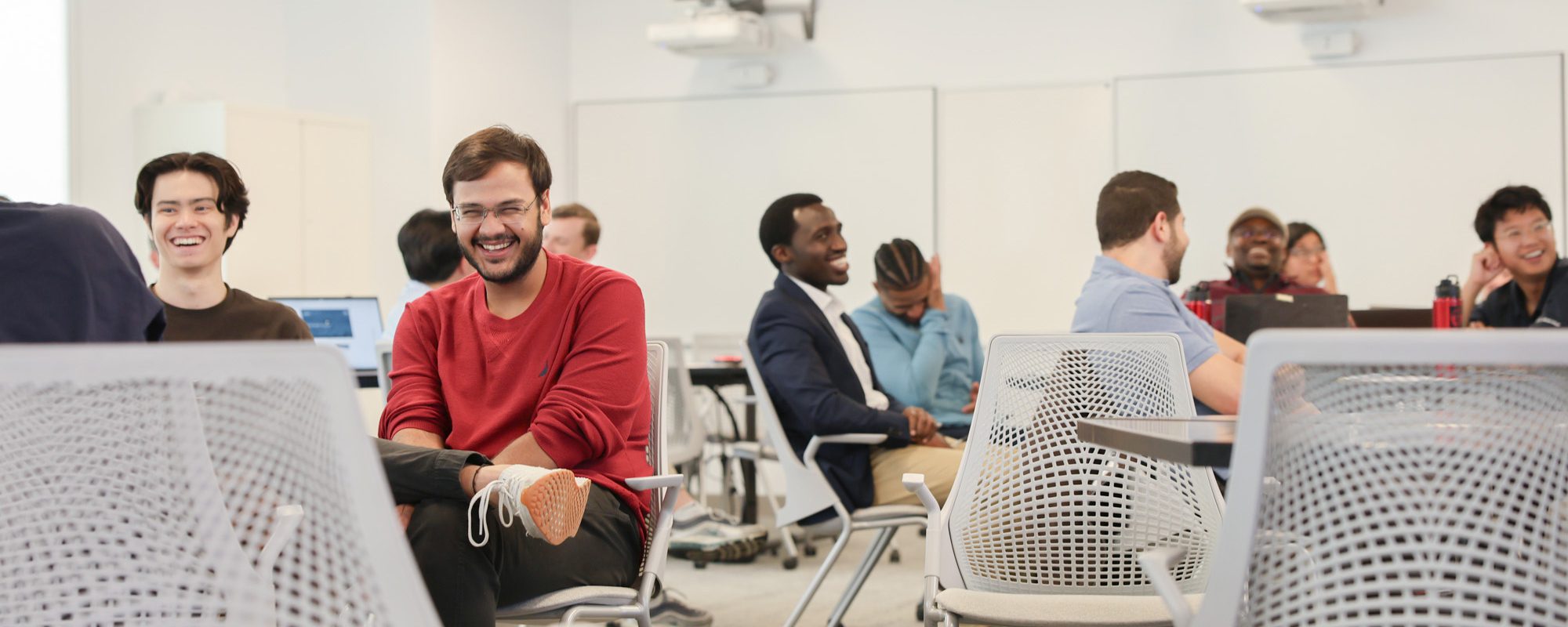 Group of students in a class room laughing
