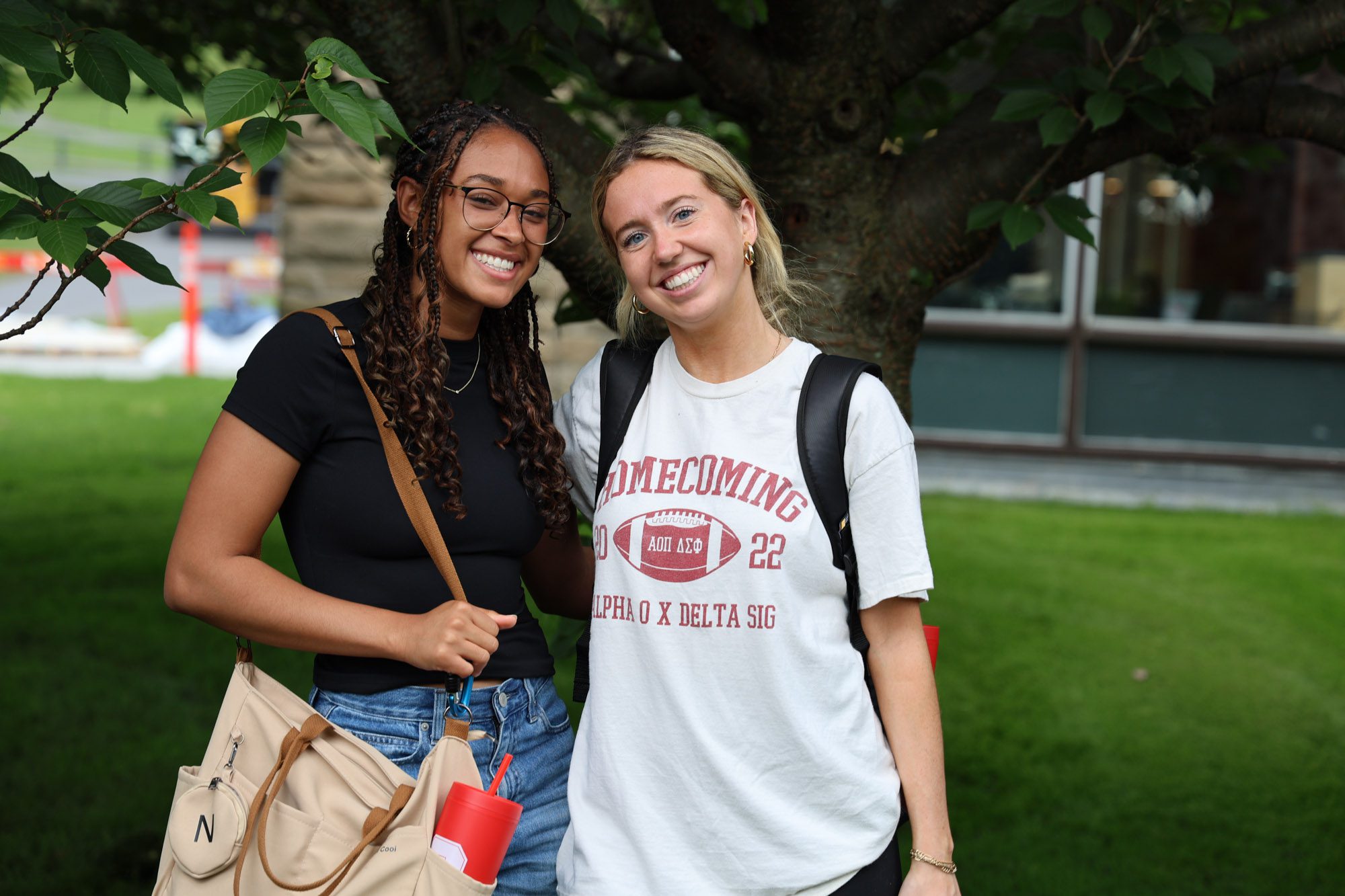 Two students smile for a photo on Cornell's Campus