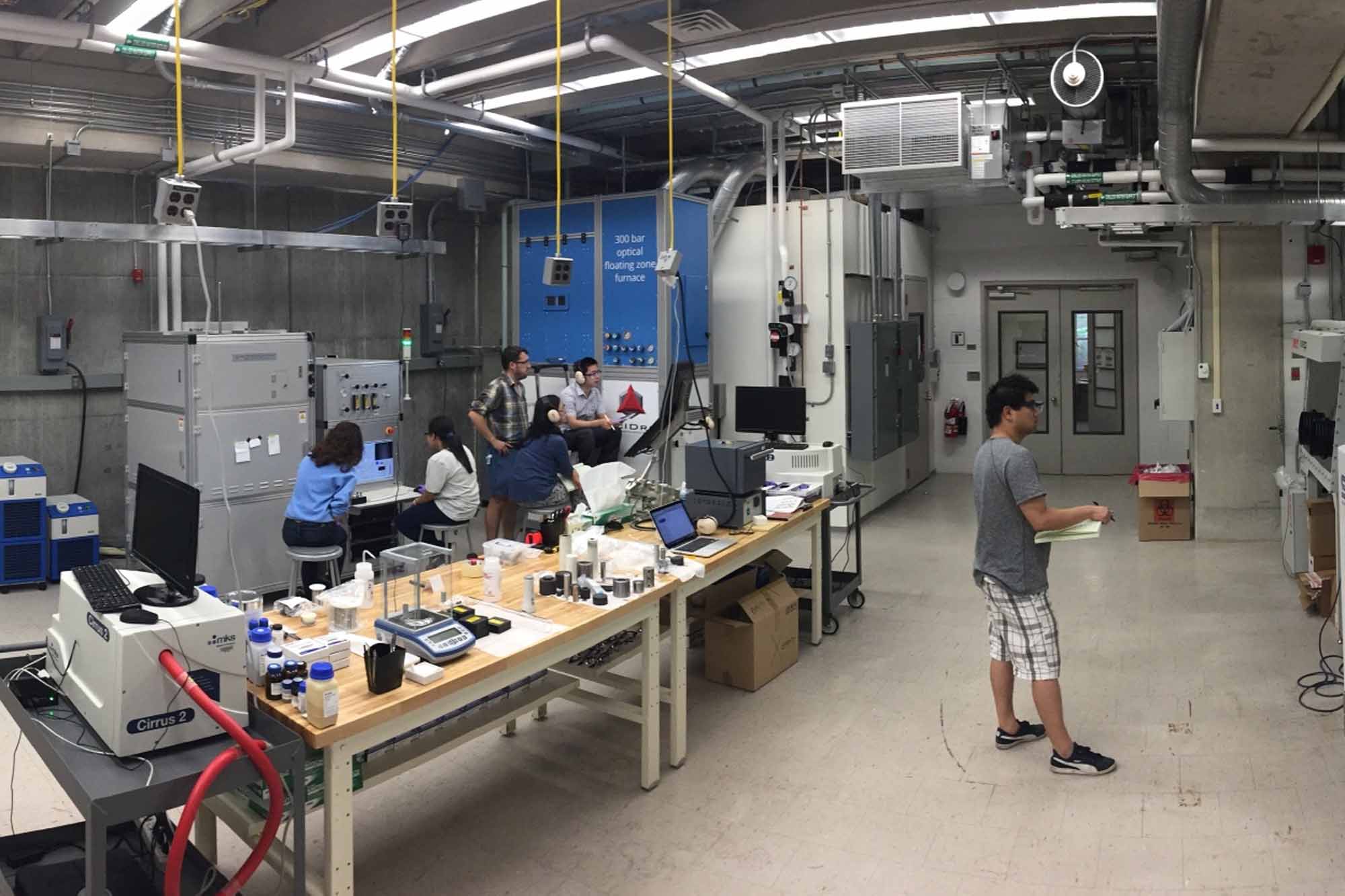 People working with instrumentation in the Bulk Crystal Growth Facility