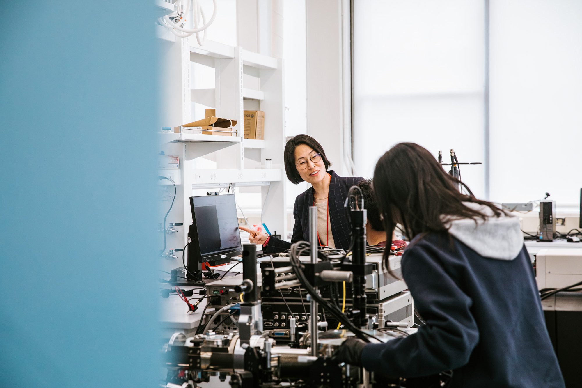 Judy Cha working with students in a lab