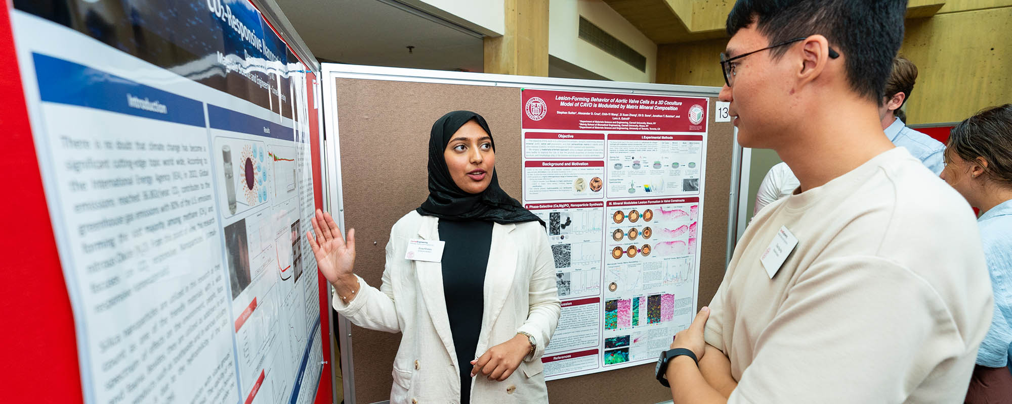 Student presenting in front of a poster board