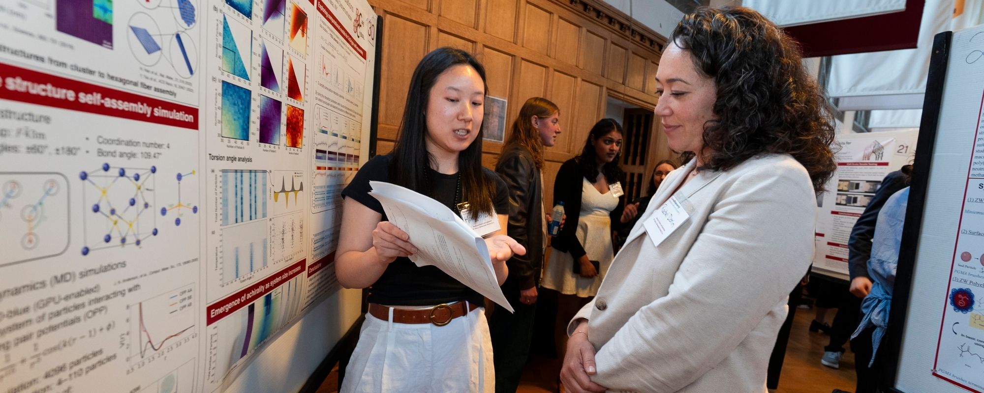 A student presenting their research poster to alumna, Rachel Dorin during the annual awards gala for MSE.
