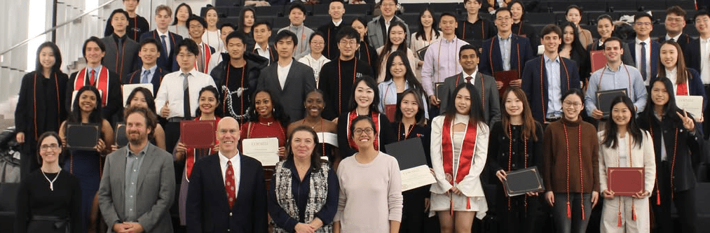 Large group of students posing together with program leadership