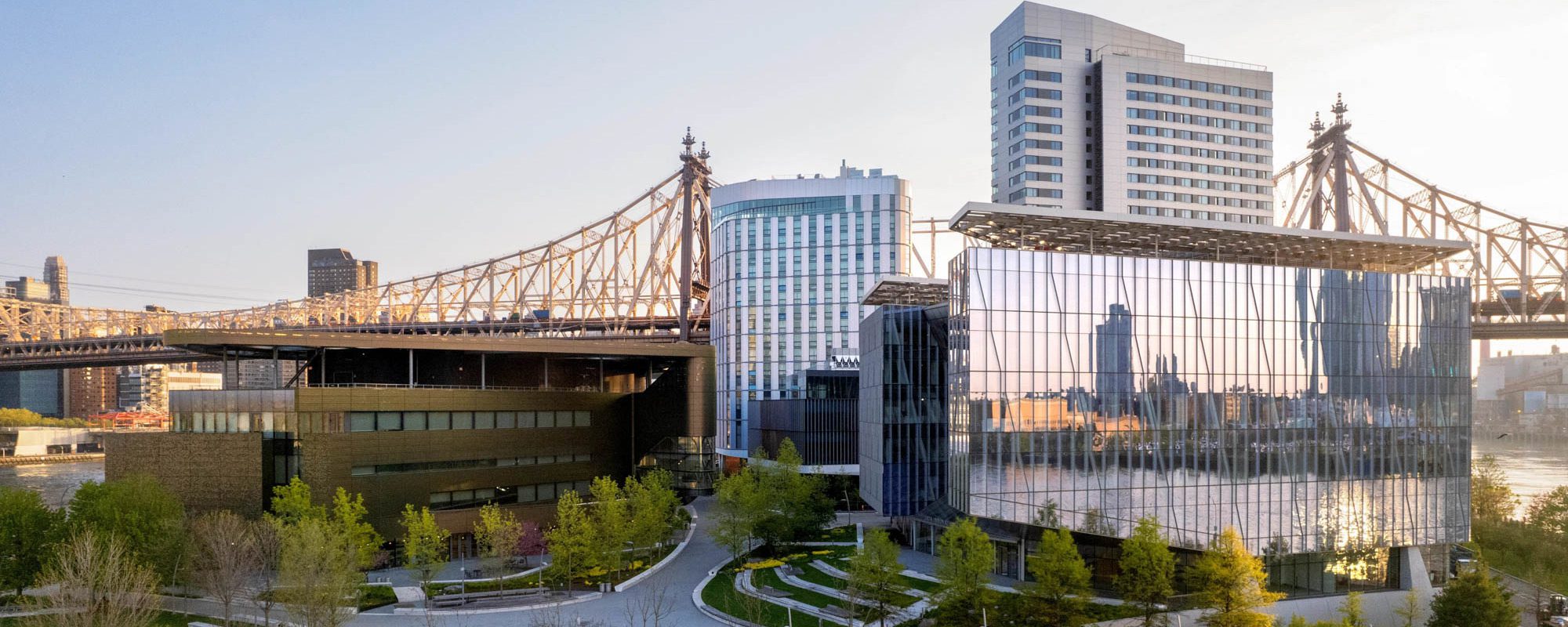 Wide view of buildings on the Cornell Tech campus with a bridge in the background