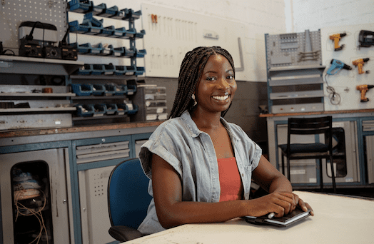 Jessica Rush Leeker sits at a table in a lab.