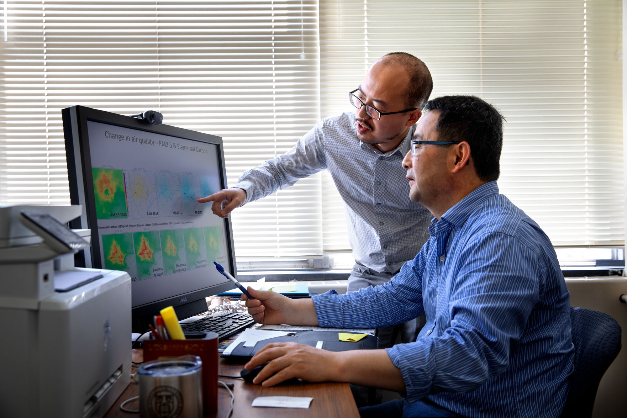 Professor Oliver Gao (front) and a graduate student study air quality in Houston Texas related to automobile emissions.