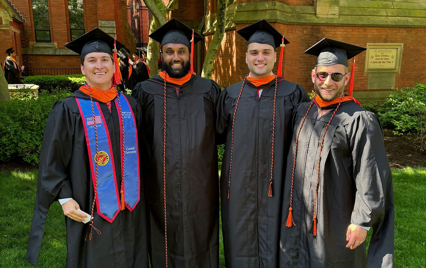 Four male students in graduation attire/