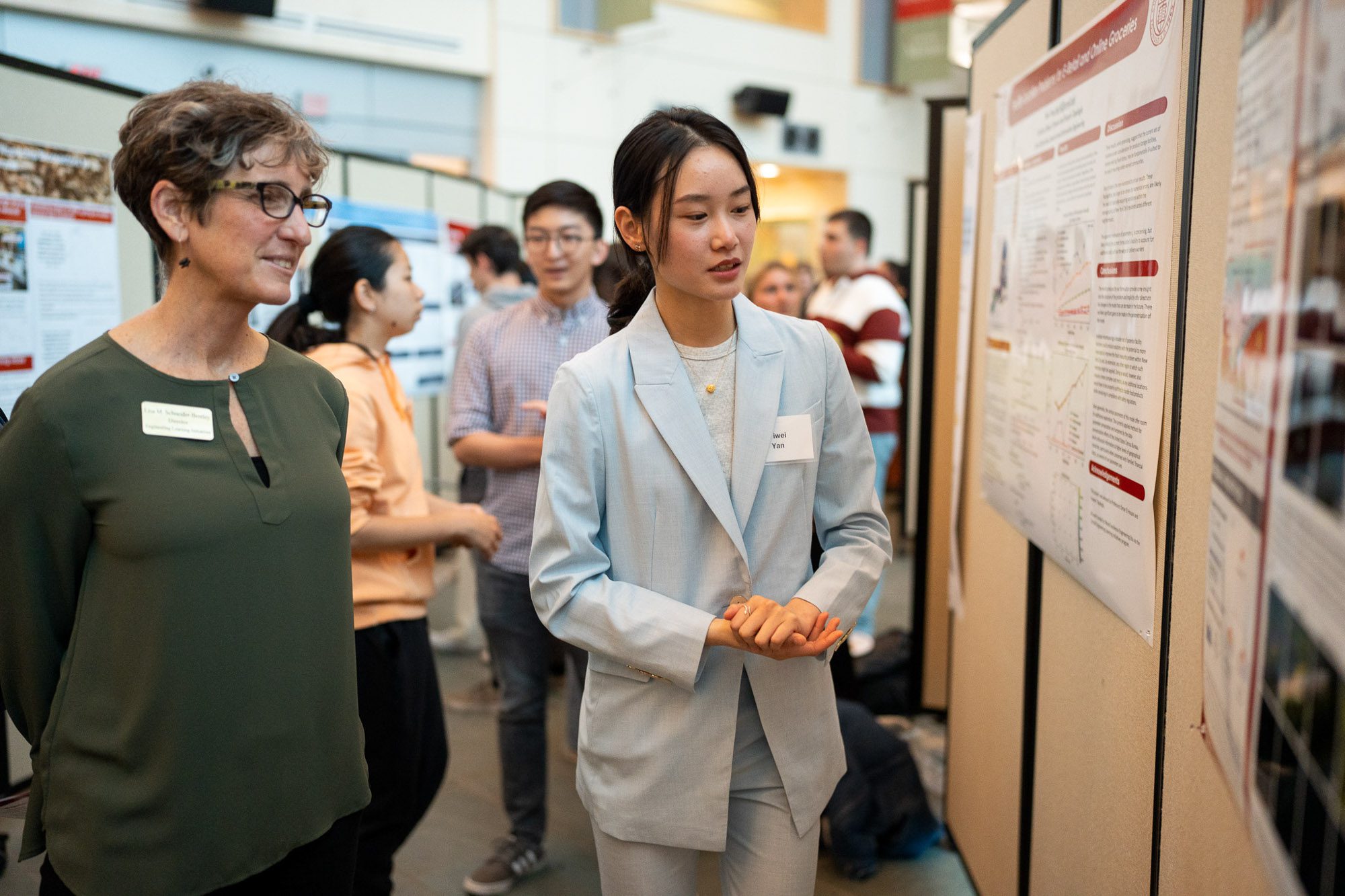 Yiwei Yan present her research to Lisa Schneider Bentley at an Undergraduate Research Poster Session