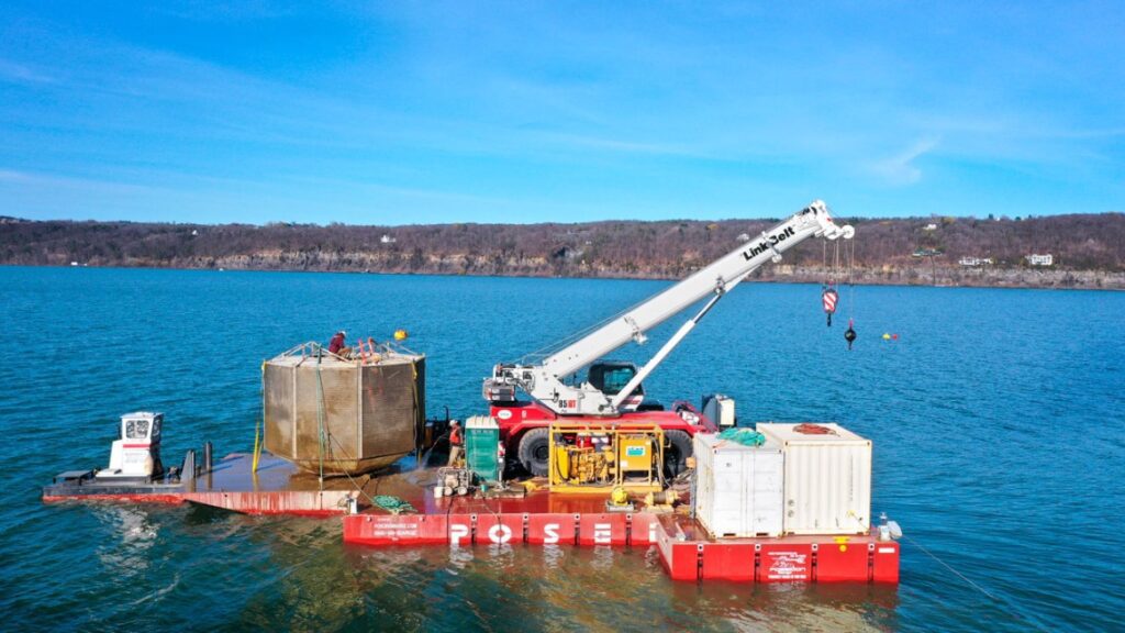 Large machine with crane on lake
