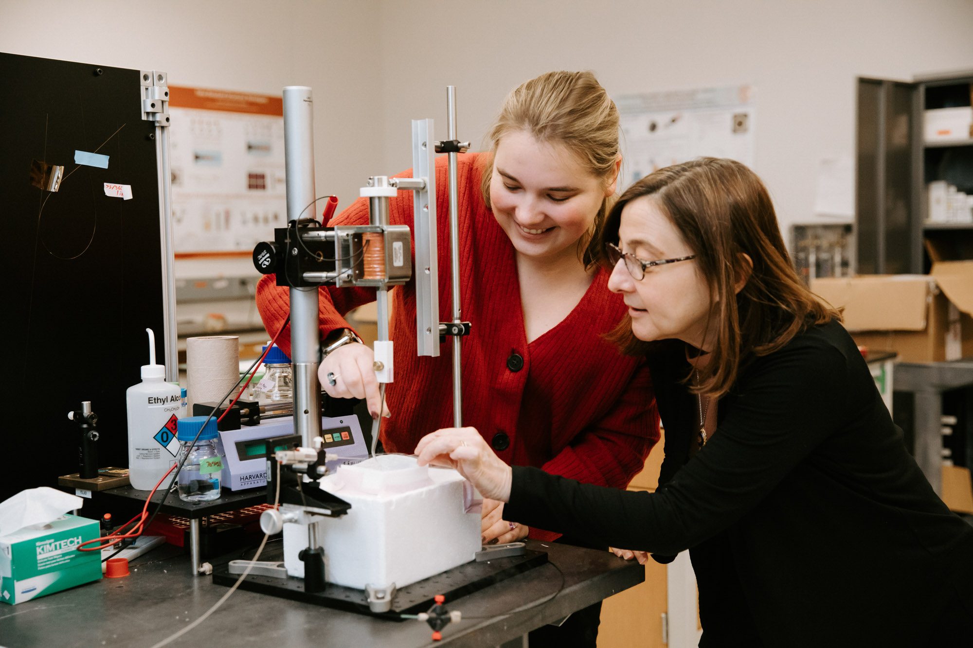 Lois Pollack and student work together at equipment