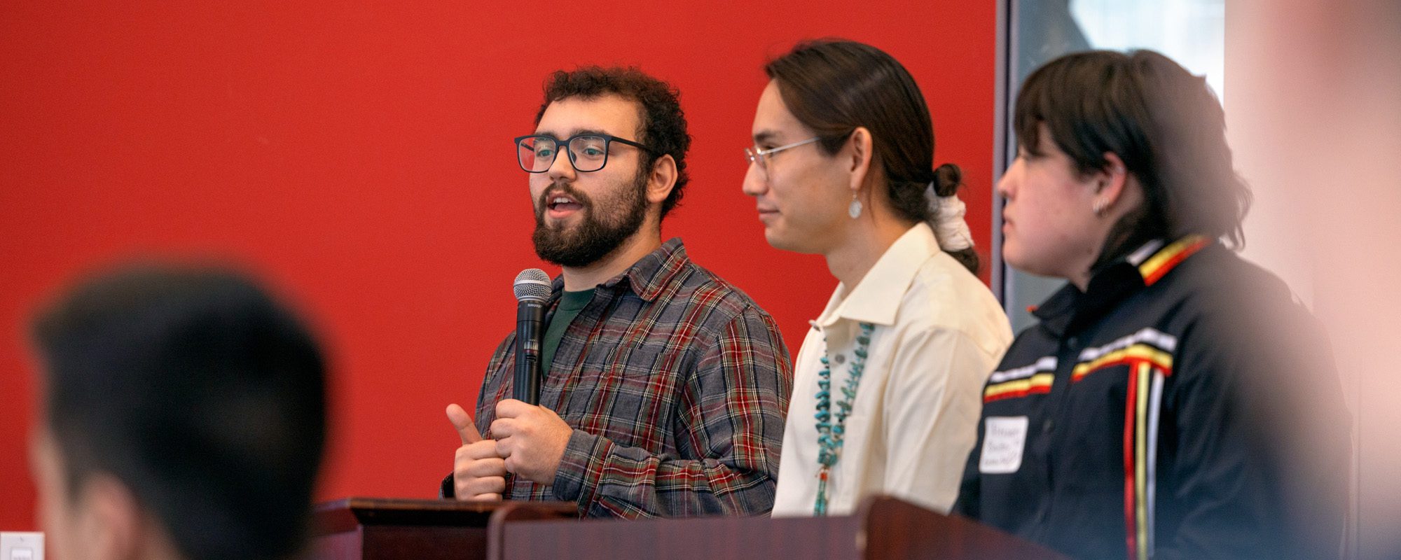 Cannon Cline speaks with three other students at the AISES regional conference