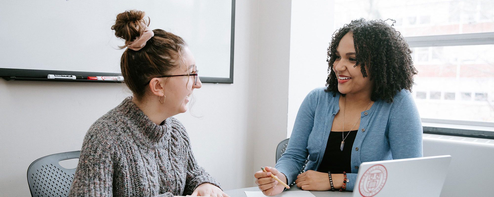 Career Center peer advisor speaks with student at table