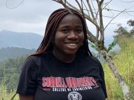 Black female student smiling outside