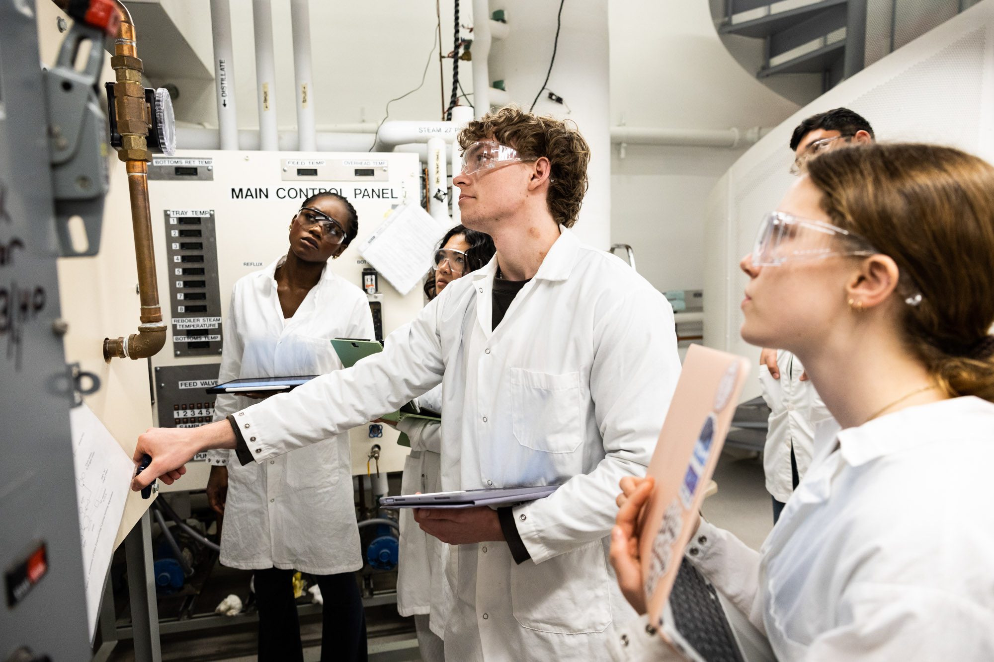 Students work together to measure the performance of a pump system in the unit operations lab