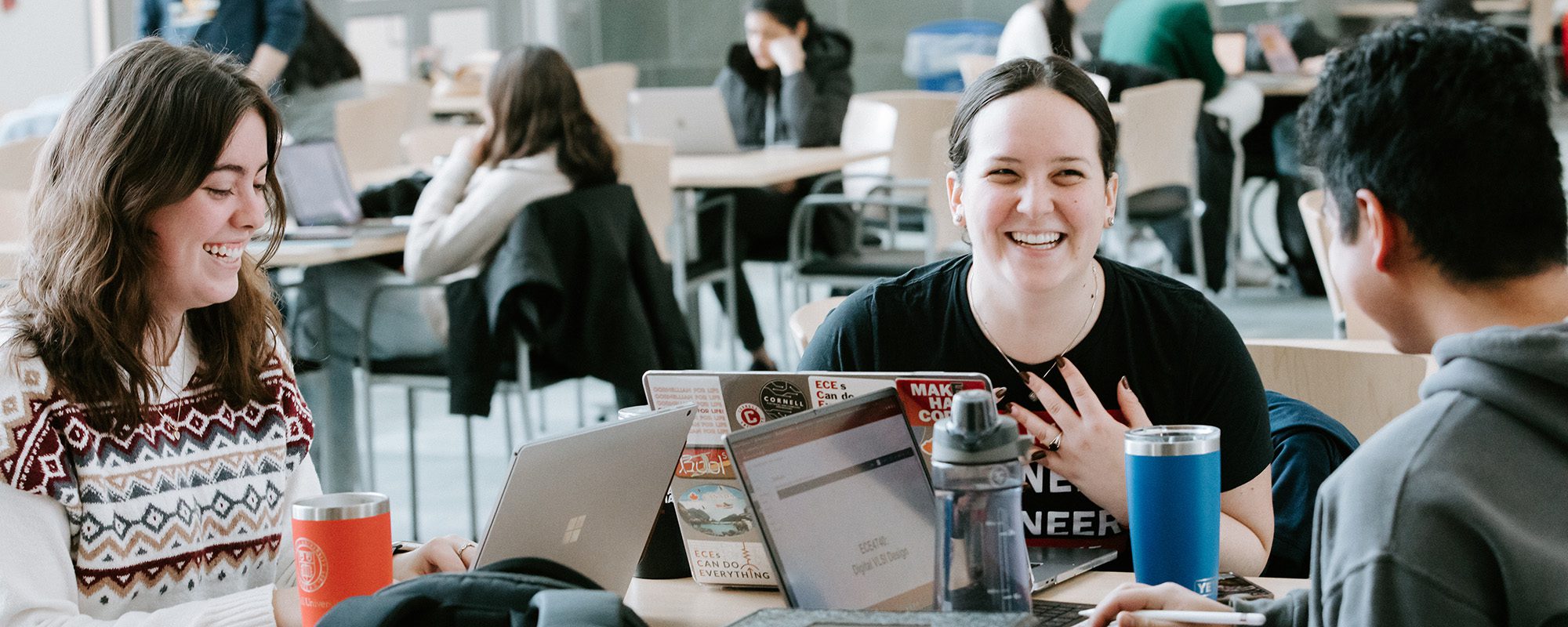 Students work together on laptops in Duffield Atrium