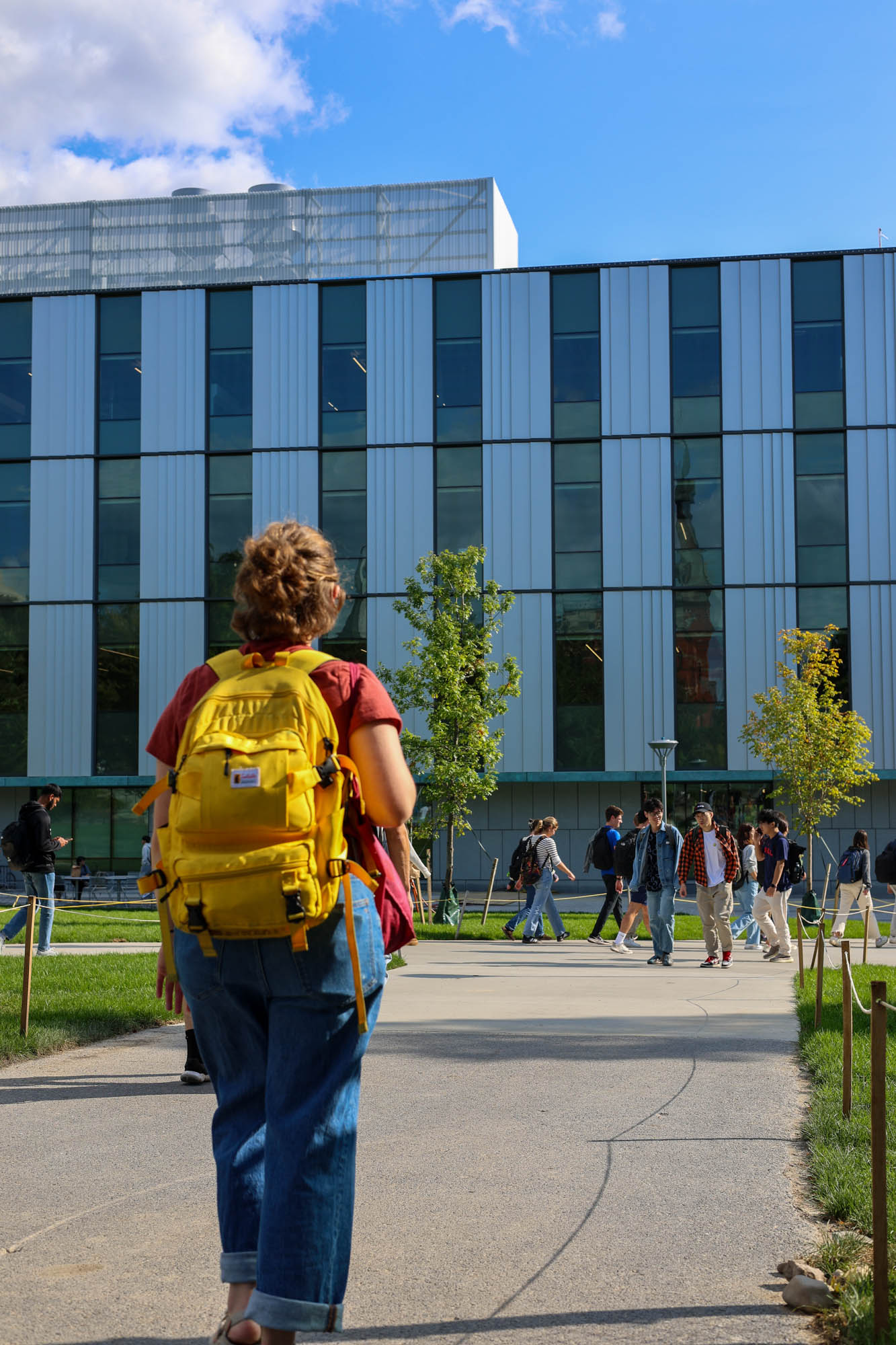 Students walk across the Engineering Quad in front of Tang Hall