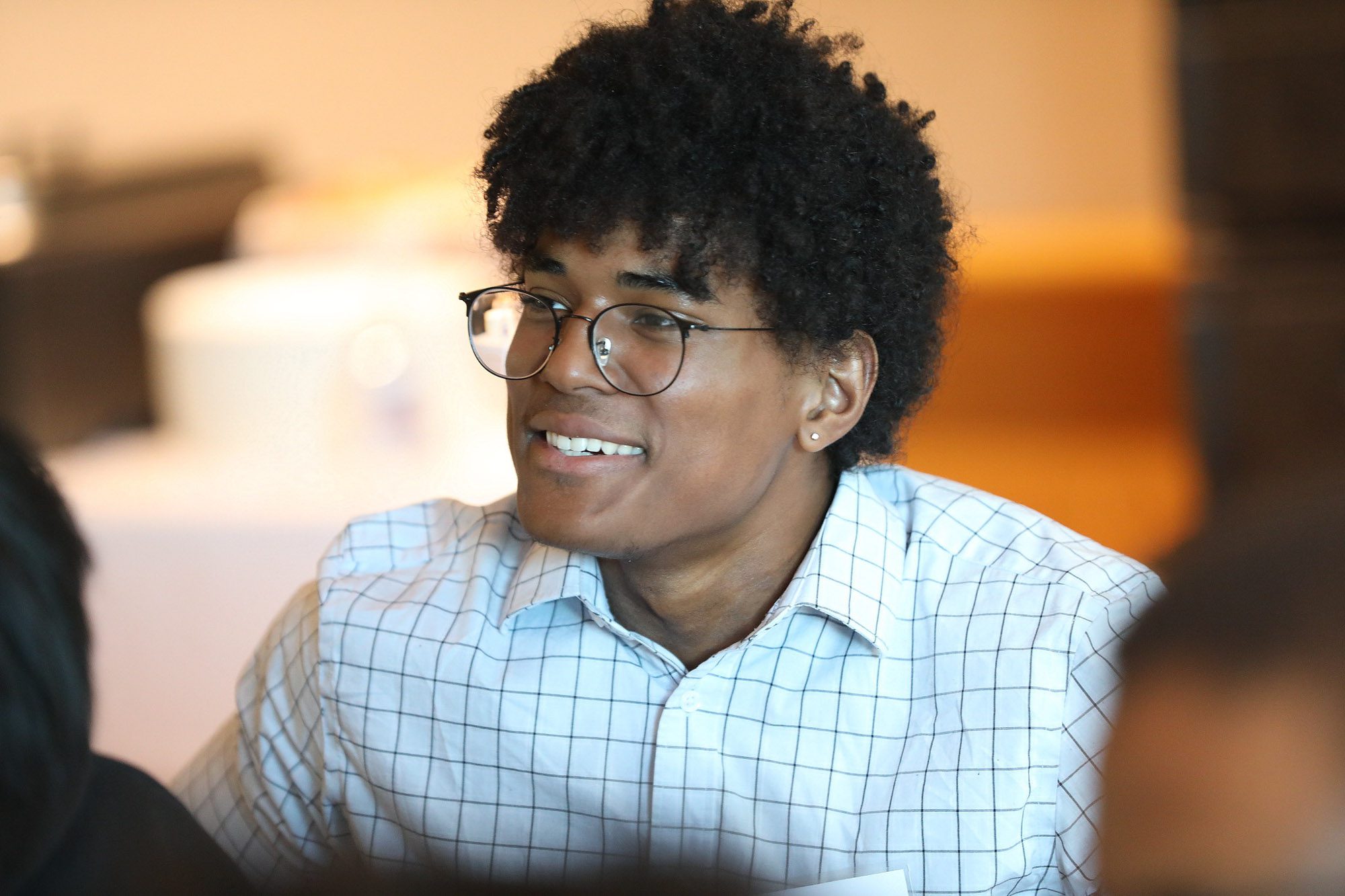 A student attends a community dinner