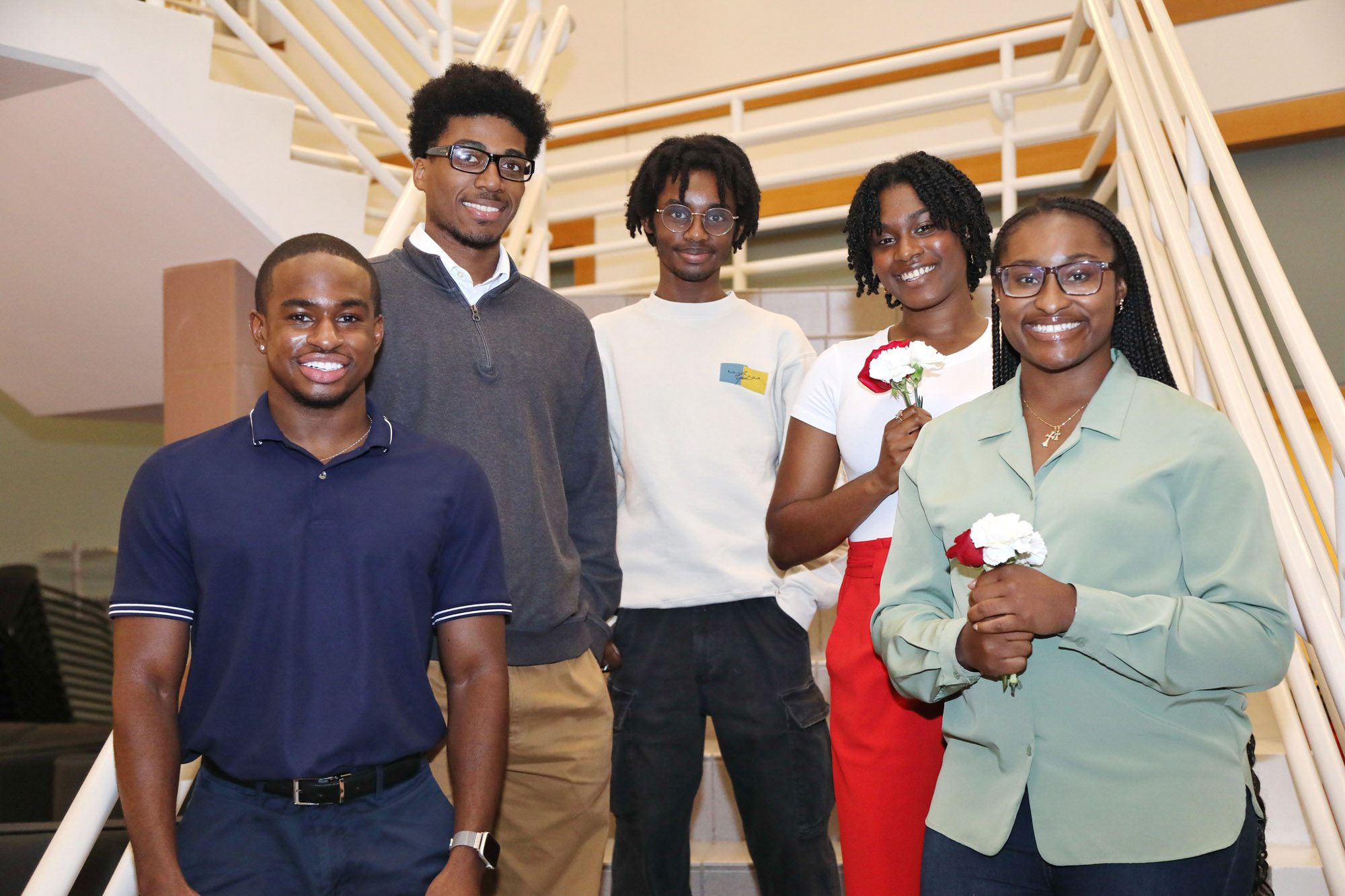 5 students smile together for a photo