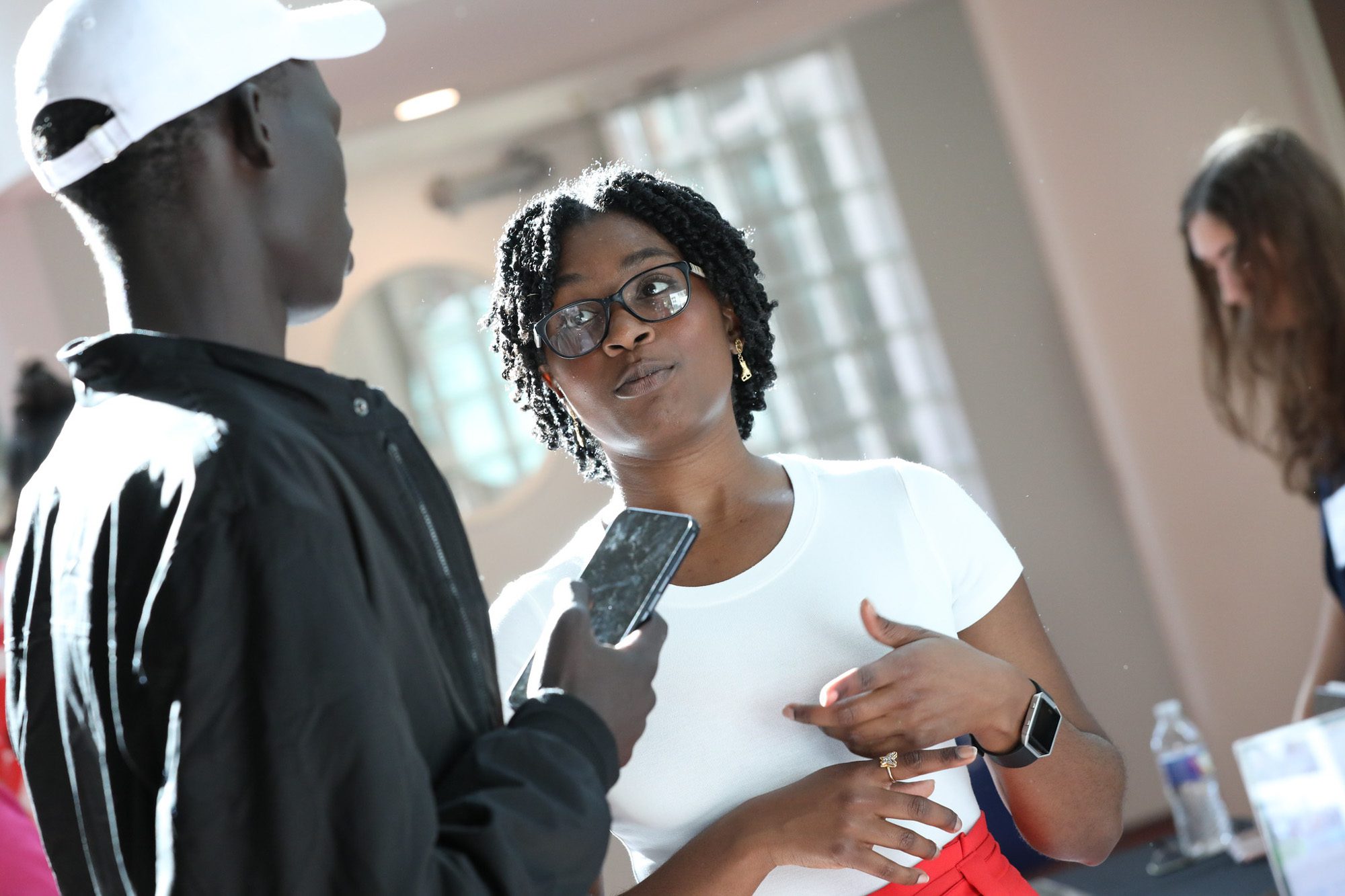 Two students talk at a community dinner