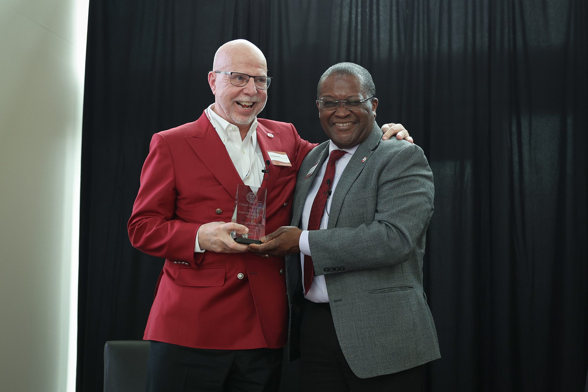 James McCormick and Lynden Archer hold McCormick's award together with arms around each other