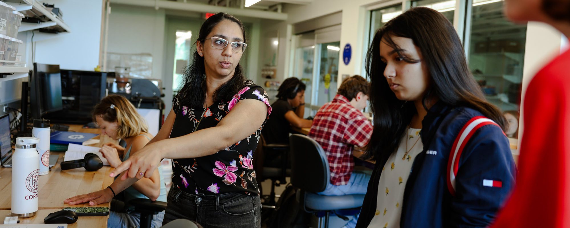 Maha Haji works with undergraduate students in the lab
