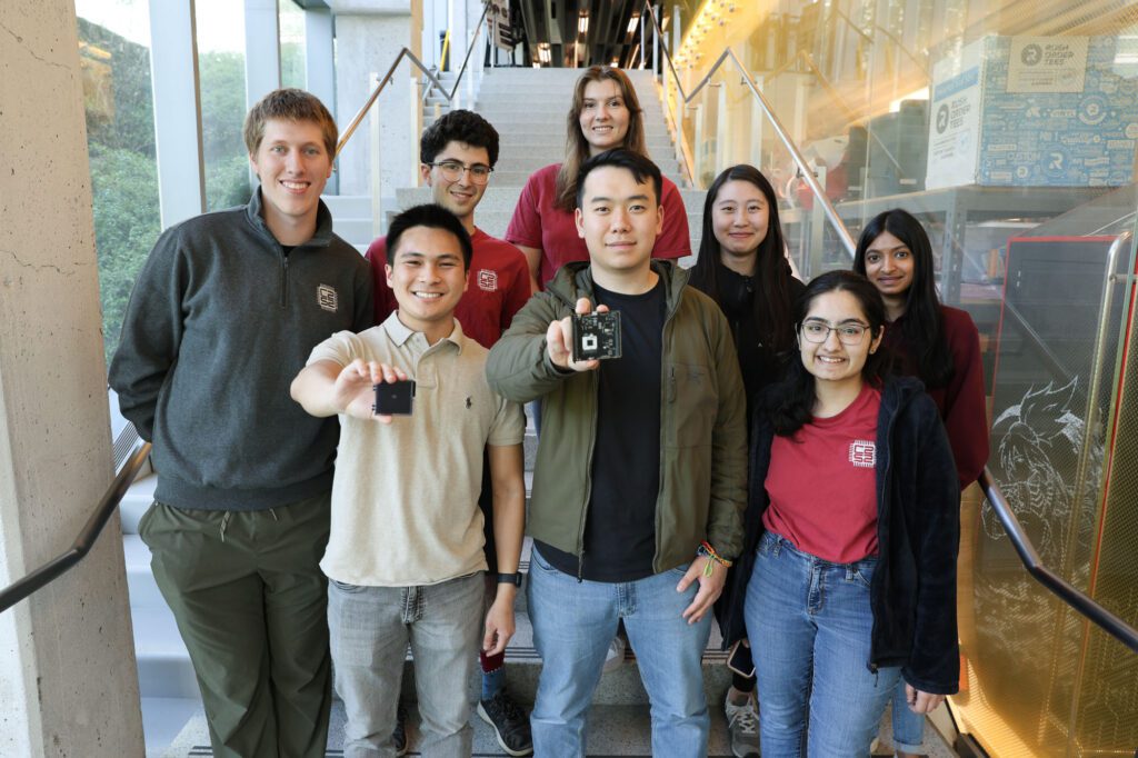 Students on the C2S2 Project Team hold up their microchips for a group photo