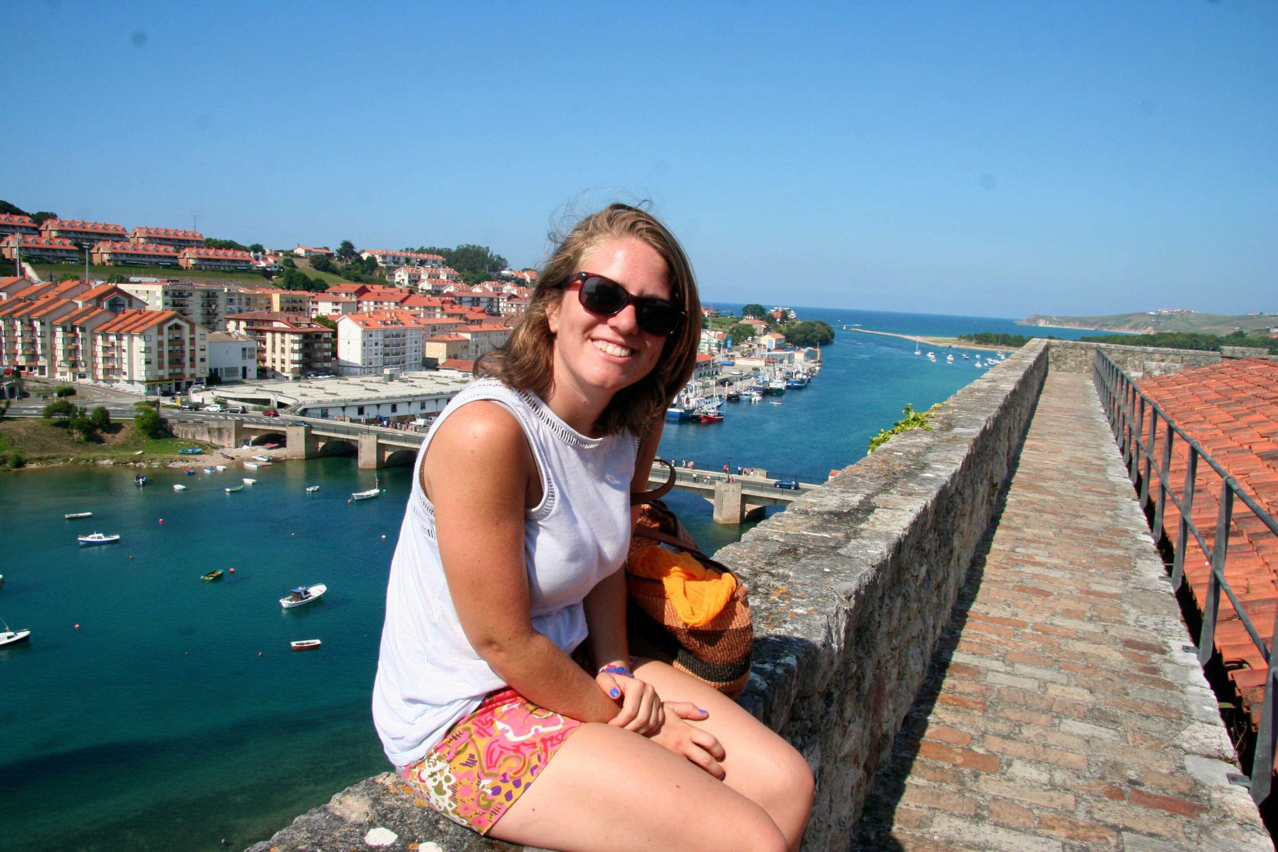 A student poses for a photo by the water during a study abroad in Cantabri, Spain