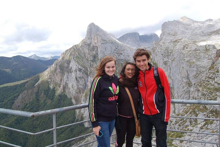 Students pose for a photo with the mountains during a study abroad in Spain