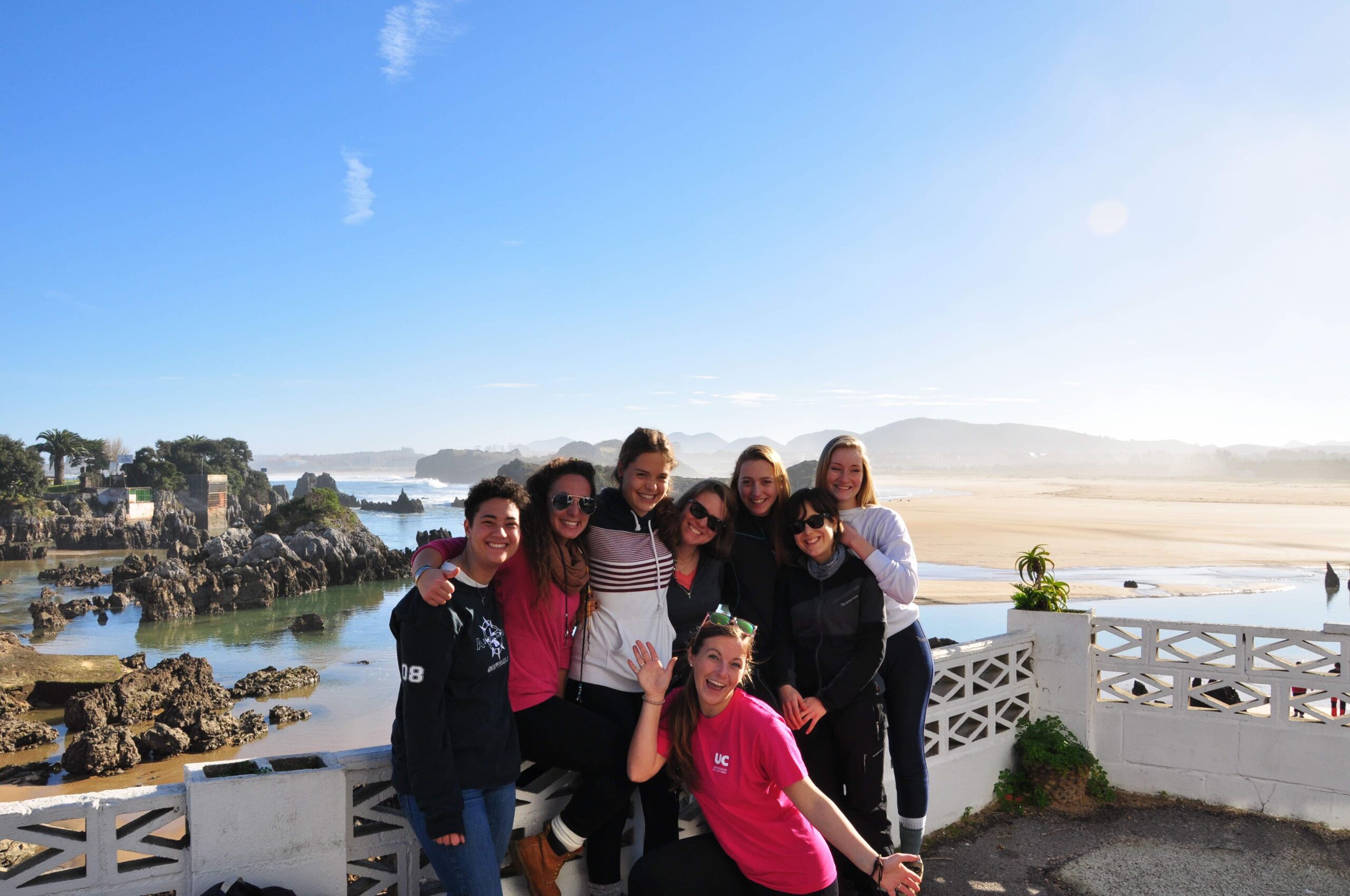 Students smile together by the water during a study abroad in Cantabri, Spain