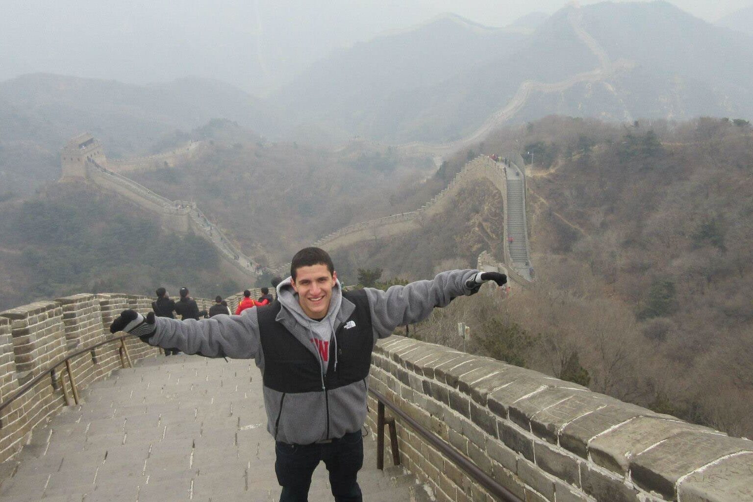 A student poses for a photo while visiting the Great Wall of China