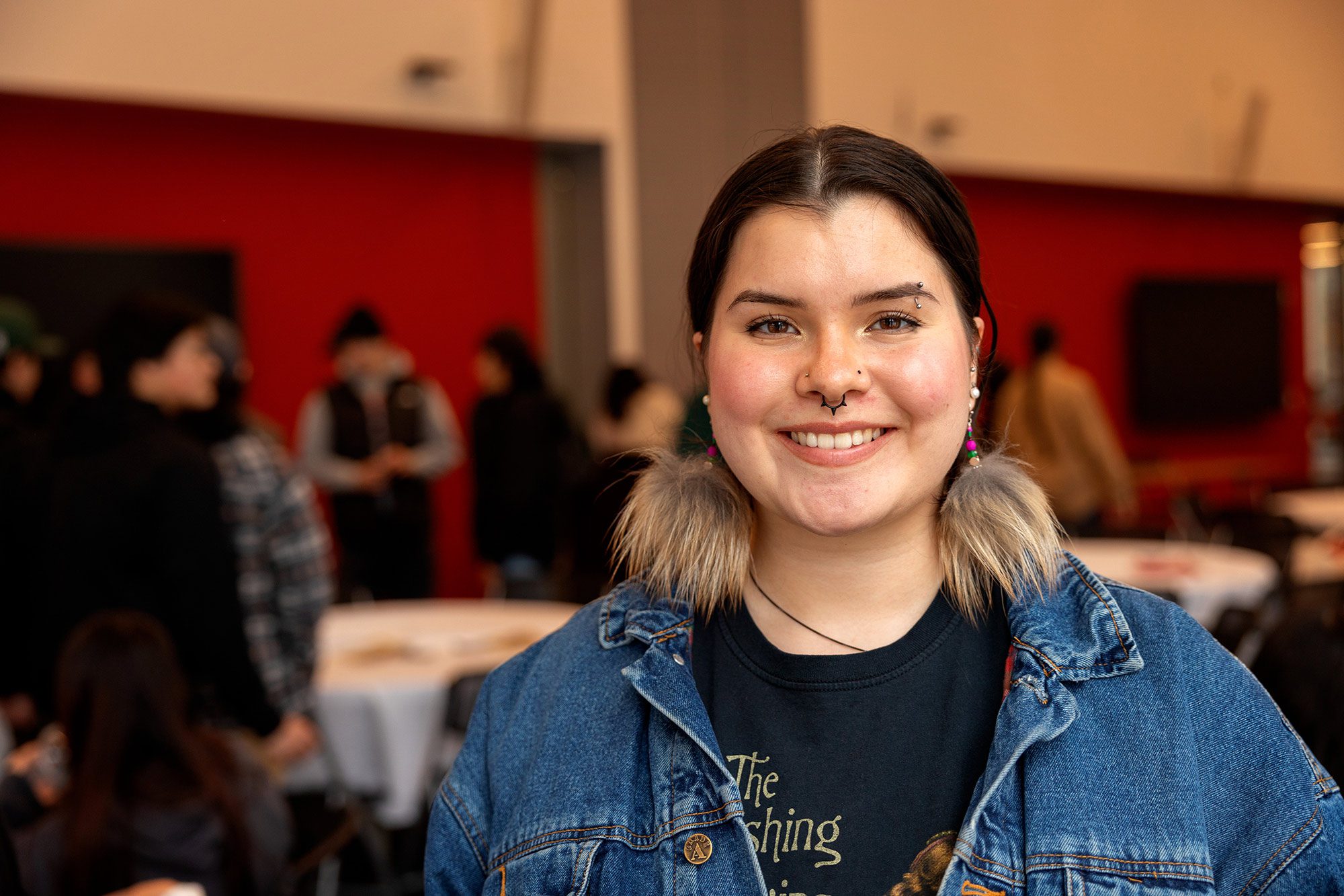 Female student smiling during an event indoors