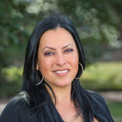 Voula Malikopoulos standing outside in front of greenery