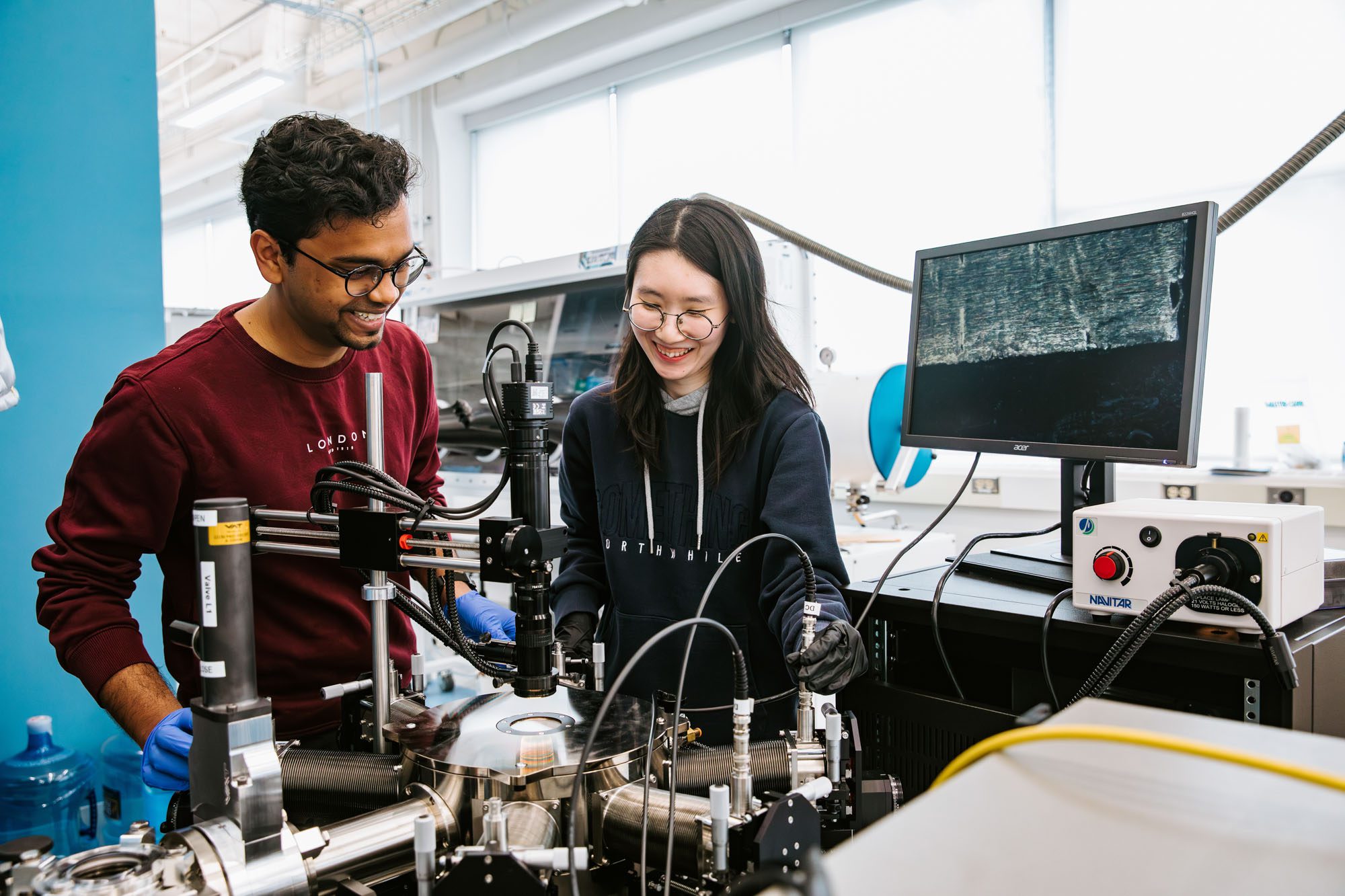 Two students work in Judy Cha's lab
