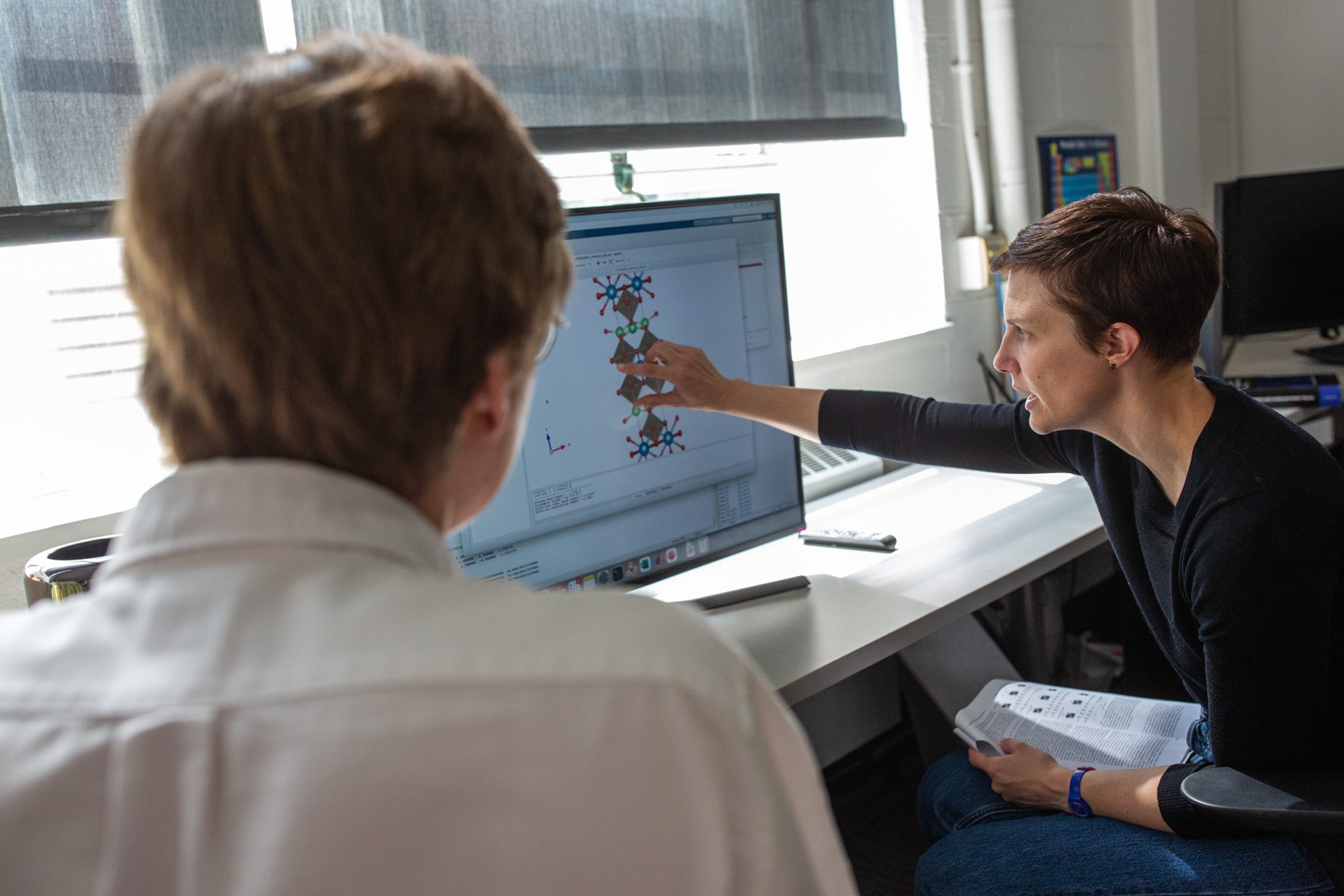 Nicole Benedek works with a student