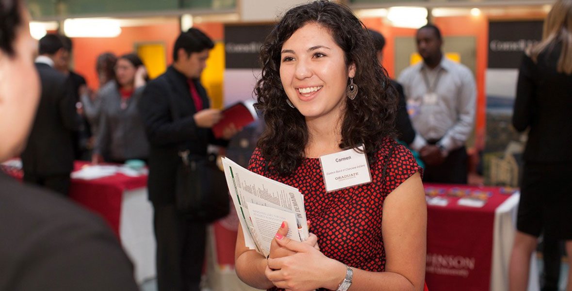 Among crowd, student talks to someone at career fair