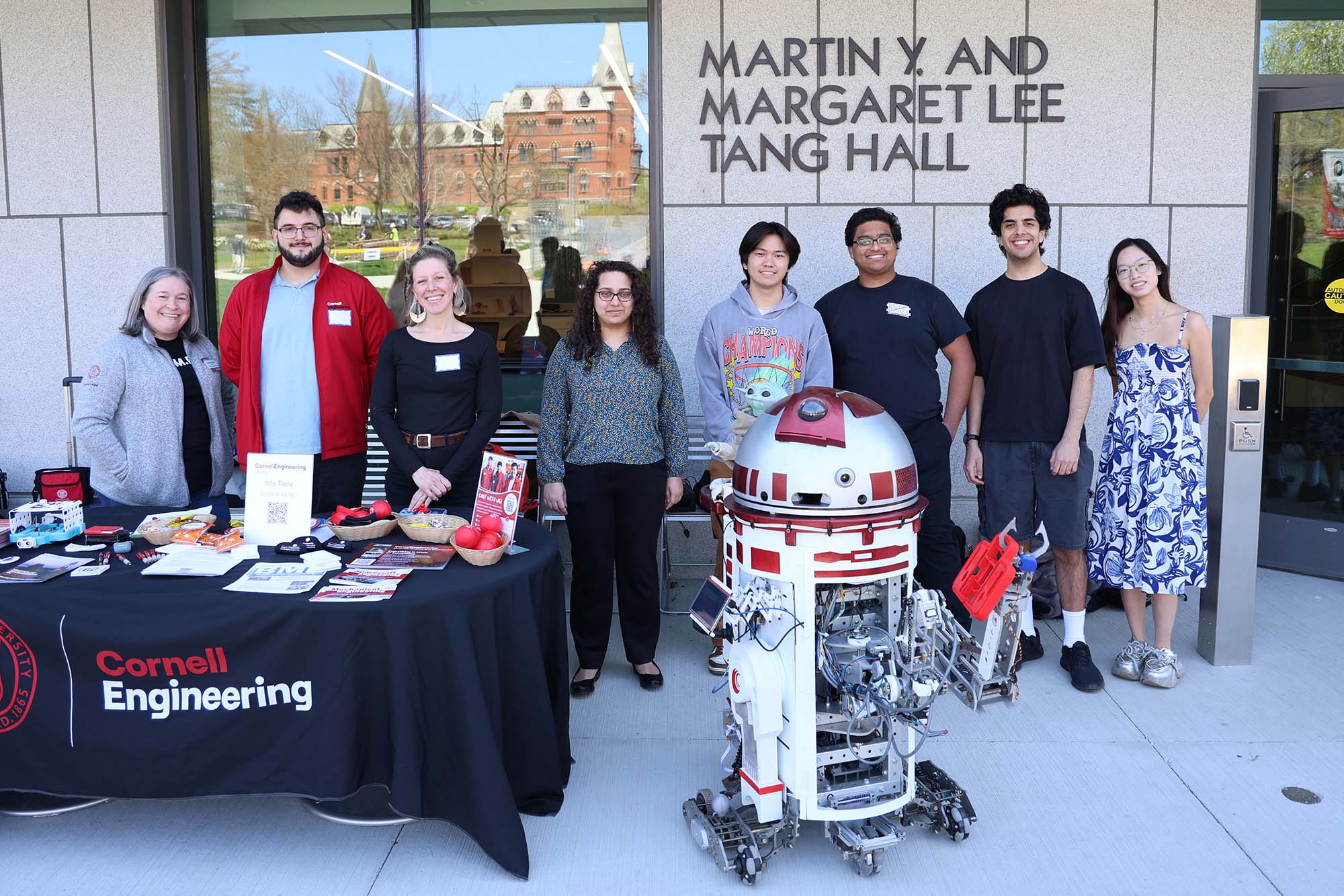 Cornell M.Eng. students and staff outside of Tang hall with a robot