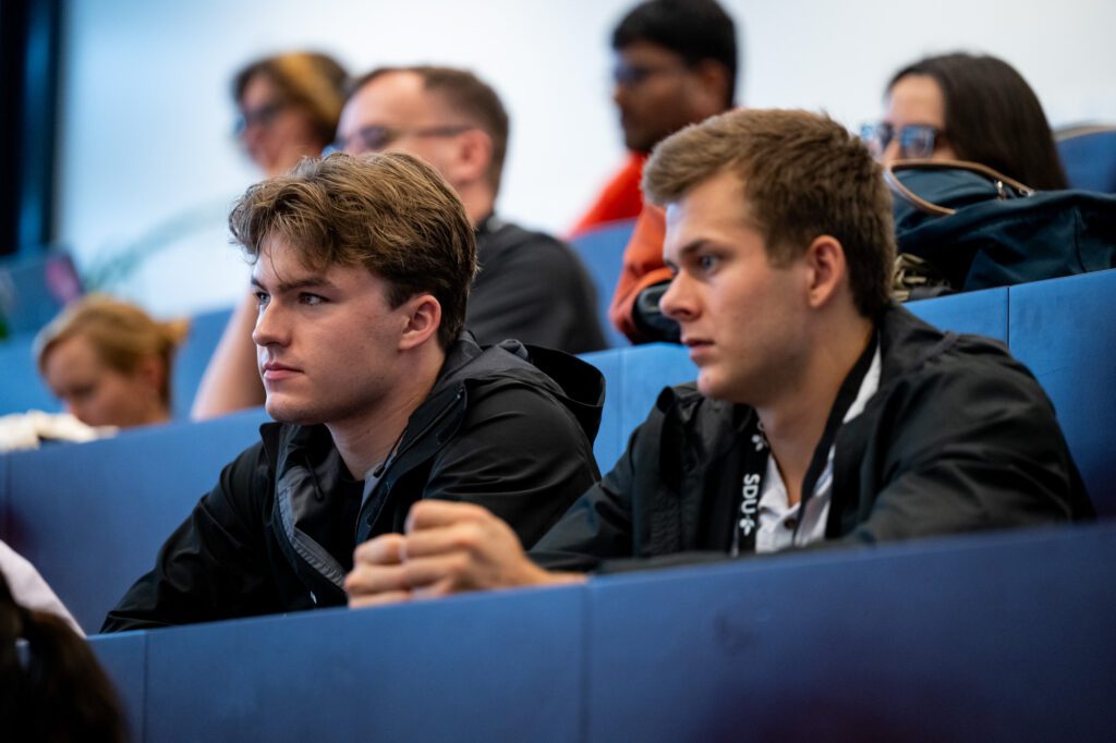Students Hudson Tumey and Luke Stewart listen to a presentation