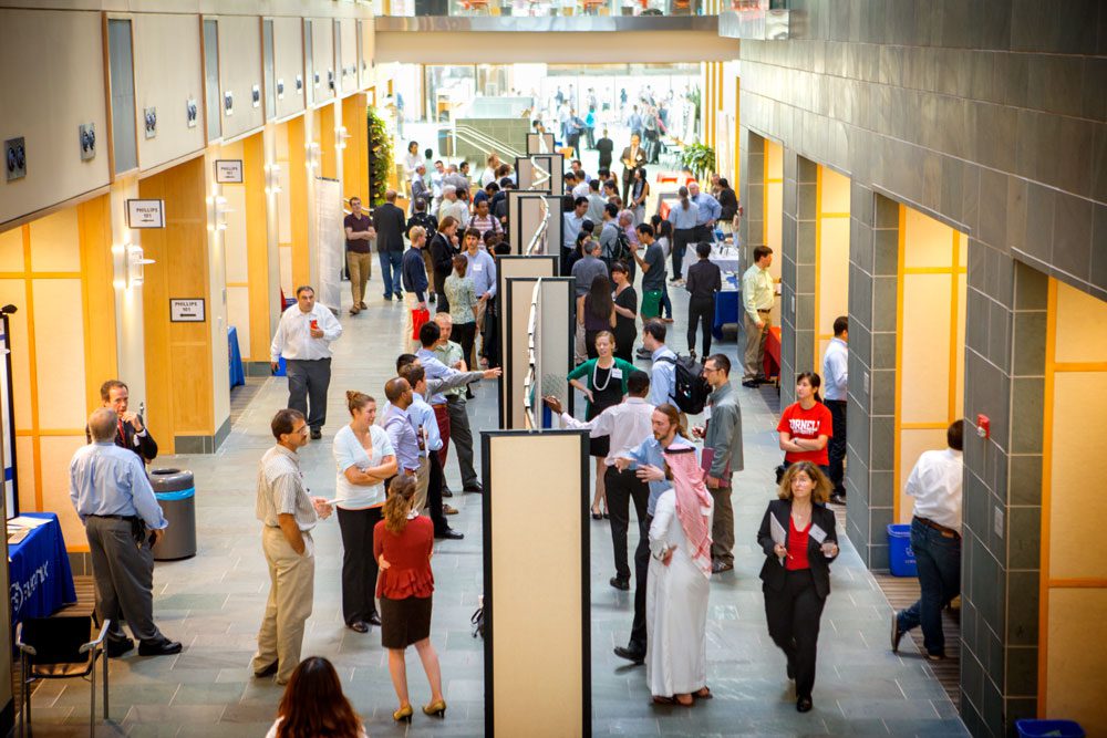 Students and faculty mingle around poster presentations