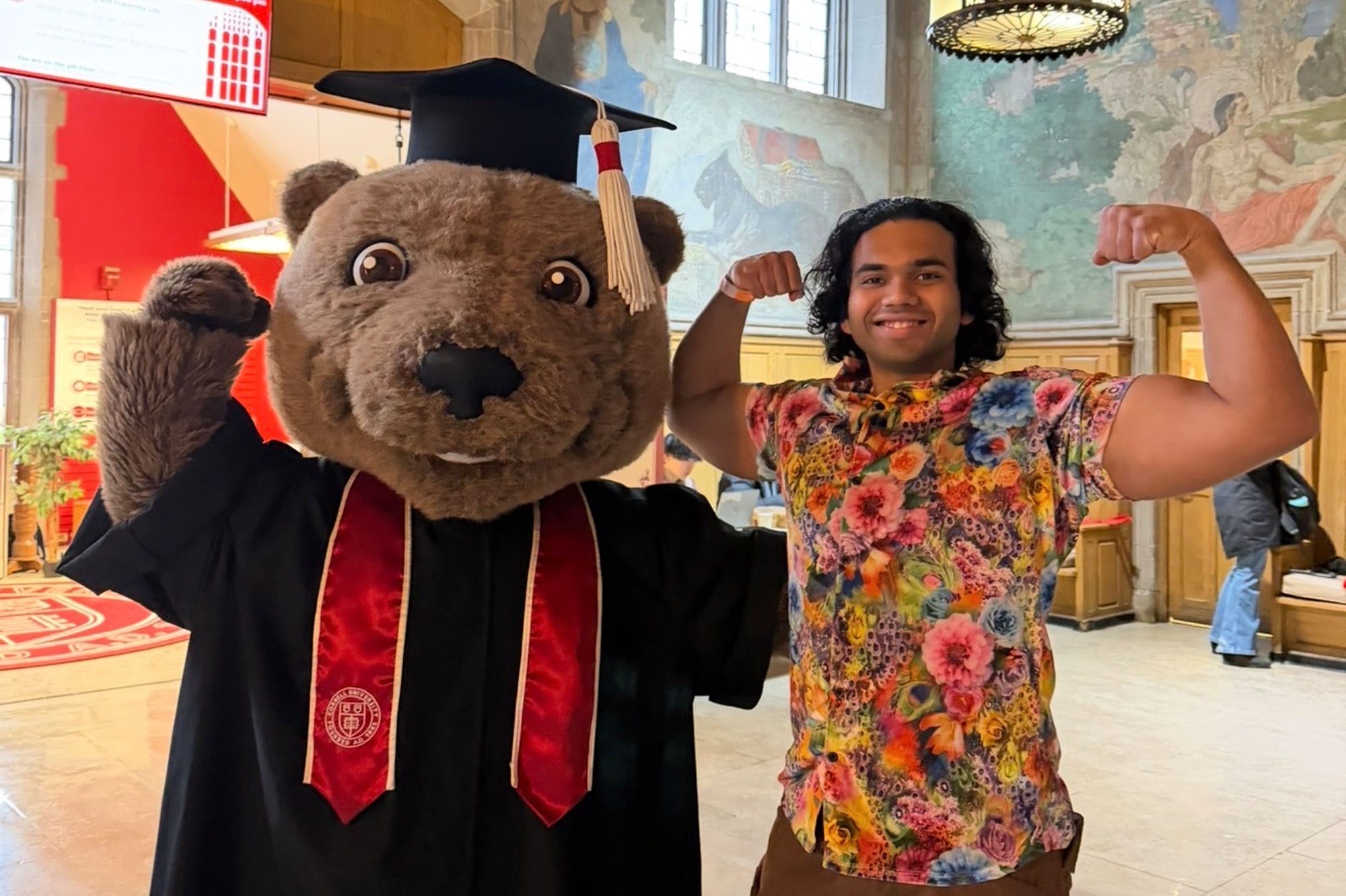 CBE M.Eng. Student Siddhant Dhende flexes with Touchdown the bear.