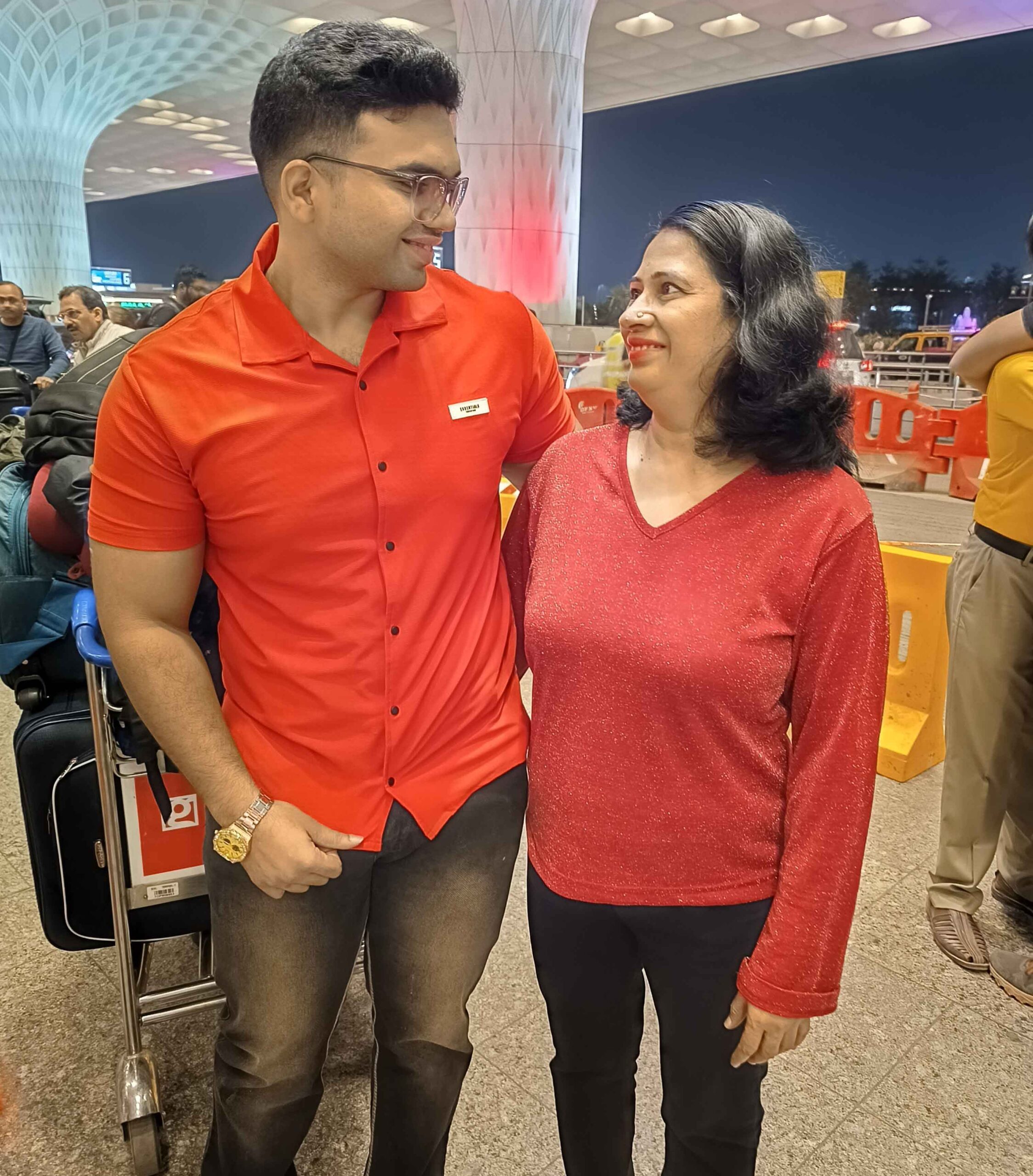 Siddhant Dhende and his mother smiling at each other.