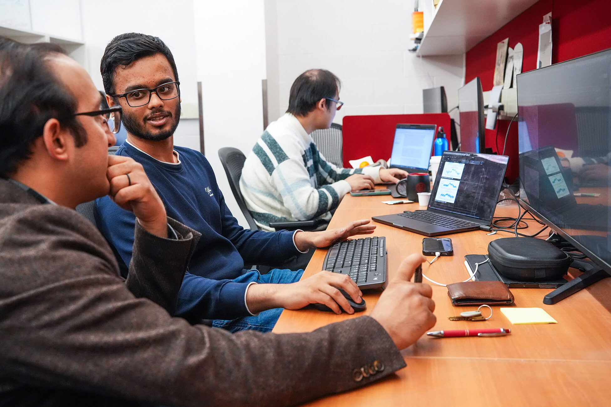 Two men set at a computer