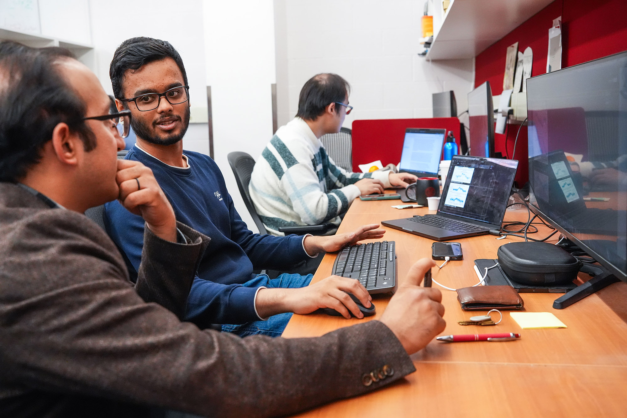Two men set at a computer