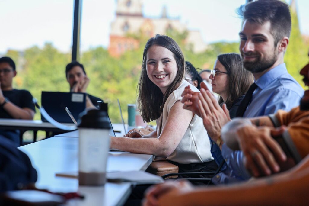 Alexandra Werth smiling in meeting with other people
