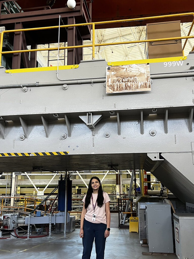Himani Mishria s standing inside an industrial building at the Lawrence Berkeley National Laboratory