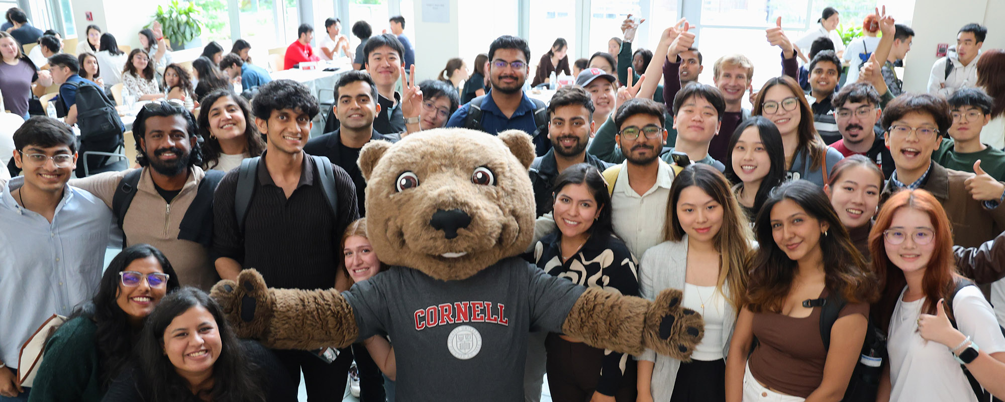 M.Eng. students with Touchdown the Bear mascot at a welcome event