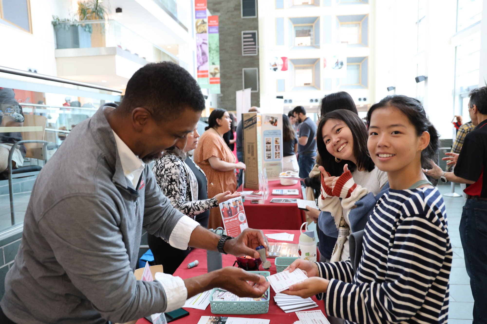 Students getting a raffle stamp at the M.Eng. Expo